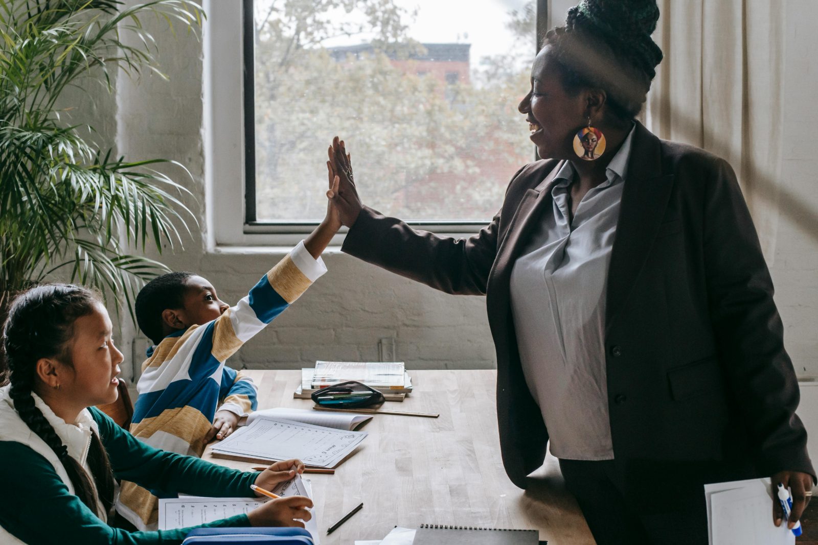 A teacher celebrating with a student