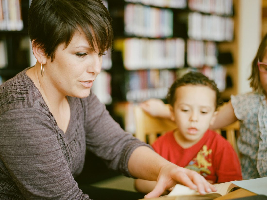 A teacher reading one-on-one with a young student